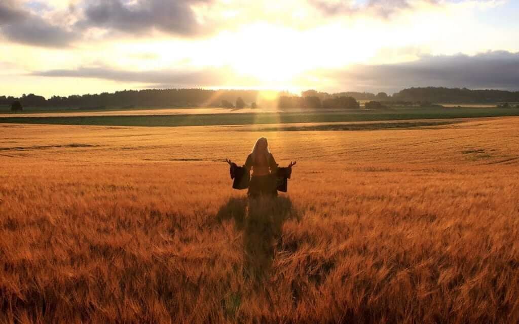 happy woman in golden wheat field